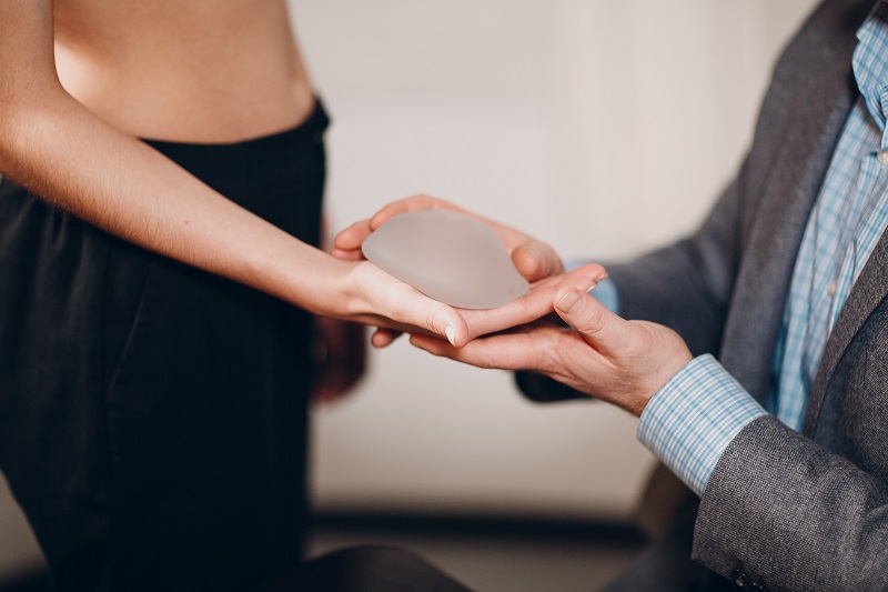 Woman selecting breast implant size in Beverly Hills