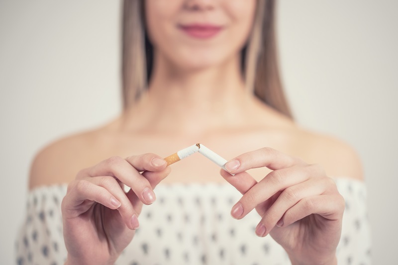 Woman quitting smoking before plastic surgery